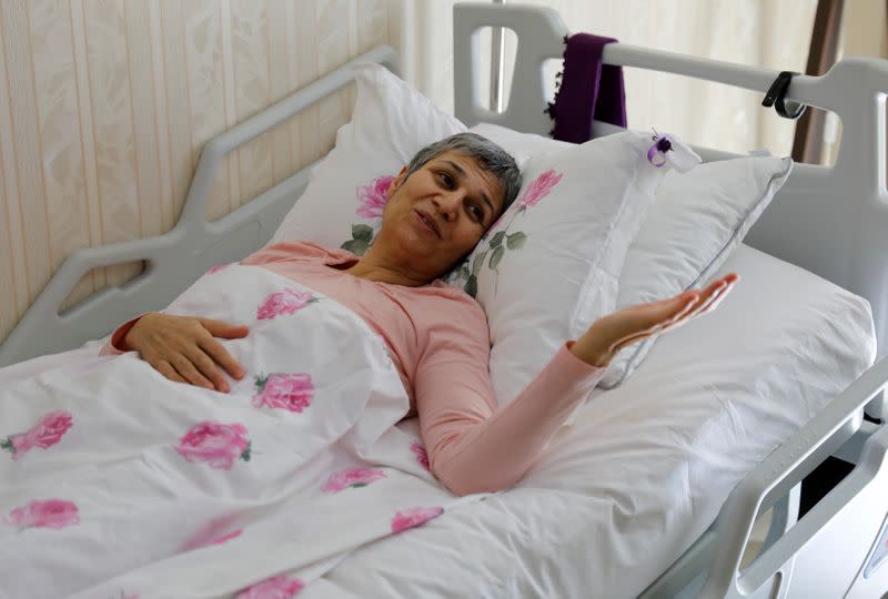 FILE PHOTO: Leyla Guven, pro-Kurdish Peoples' Democratic Party (HDP) lawmaker who has been on a hunger strike for more than four months, gestures as she rests in her bed at her home in Diyarbakir