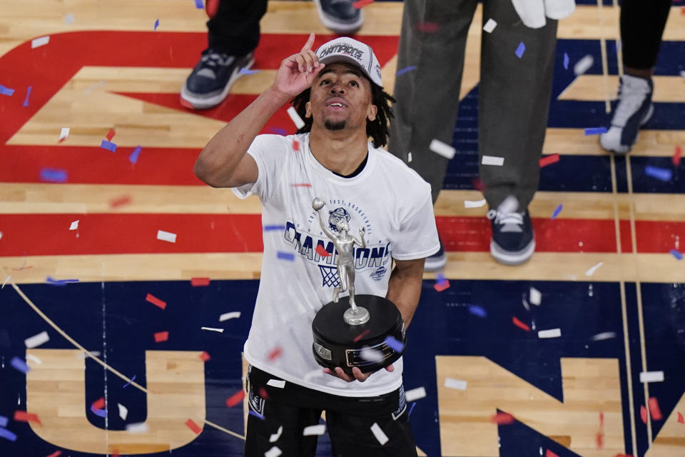 Georgetown's Dante Harris celebrates while holding the Most Outstanding Player trophy after an NCAA college basketball game against Creighton in the championship of the Big East Conference tournament Saturday, March 13, 2021, in New York. (AP Photo/Frank Franklin II)