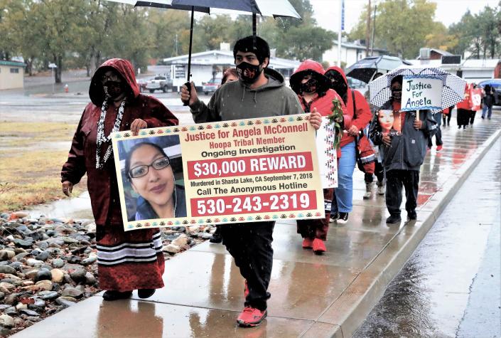 Tammy Carpenter, left, and her son, Richie, carry a sign during a prayer walk in Shasta Lake on Saturday, Oct. 23, 2021, for their daughter and sister, Angela McConnell, who was murdered Sept. 7, 2018, in Shasta Lake. The homicide case of McConnell and her boyfriend, Michael Bingham Jr., on Black Canyon Road remains unsolved. &quot;The purpose for us is to let people know that she's not forgotten. That's what I feel in my heart that I have to be Angela Lynne McConnell's voice. I'm her mother,&quot; Tammy Carpenter said. The march also raised awareness of other Native American men and women who are listed by the Murdered and Missing Indigenous Women movement. About 30 people participated in the walk in the rain from the Wintu Cultural Center on Shasta Dam Boulevard to Clair Engle Park.