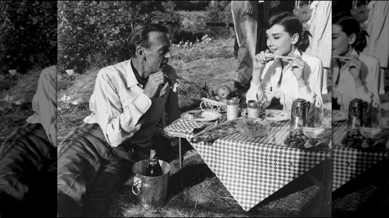 Audrey Hepburn and Gary Cooper picnicking on the set of 'Love in the Afternoon' 