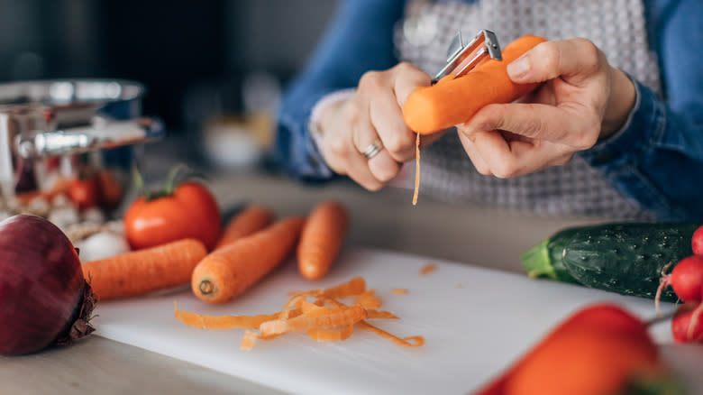 woman peeling a carrot