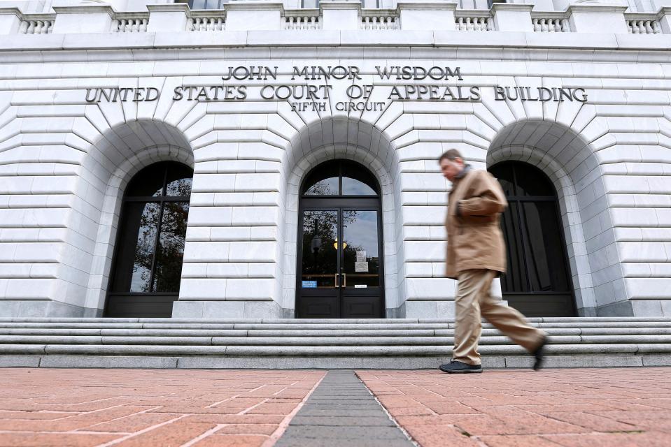 A man walks in front of the 5th U.S. Circuit Court of Appeals in New Orleans. An all-Republican three-judge panel of that court upheld a Texas law that requires parental consent for minors seeking to access contraception services.