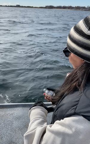 <p>Jodi T</p> Jodi Thomas tosses a "skull-shaped" bottle containing a note to her late father off the coast of Provincetown, Massachusetts in November 2021.