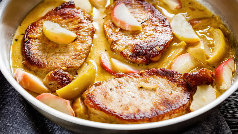 Close-up of pork chops in an apple cream sauce