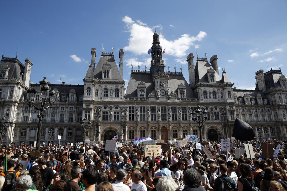 Thousands of people gather in front of Paris town hall during a protest, Saturday, Sept. 8, 2018. Demonstrators in cities across France and Europe were marching on Saturday as part of a global day of protest ahead of a climate action summit this month in San Francisco, California. (AP Photo/Christophe Ena)