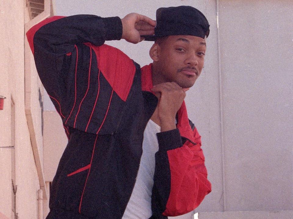 Will Smith wearing a cap backwards and a black-and-red sweatsuit on the set of "The Fresh Prince of Bel-Air" in 1990.