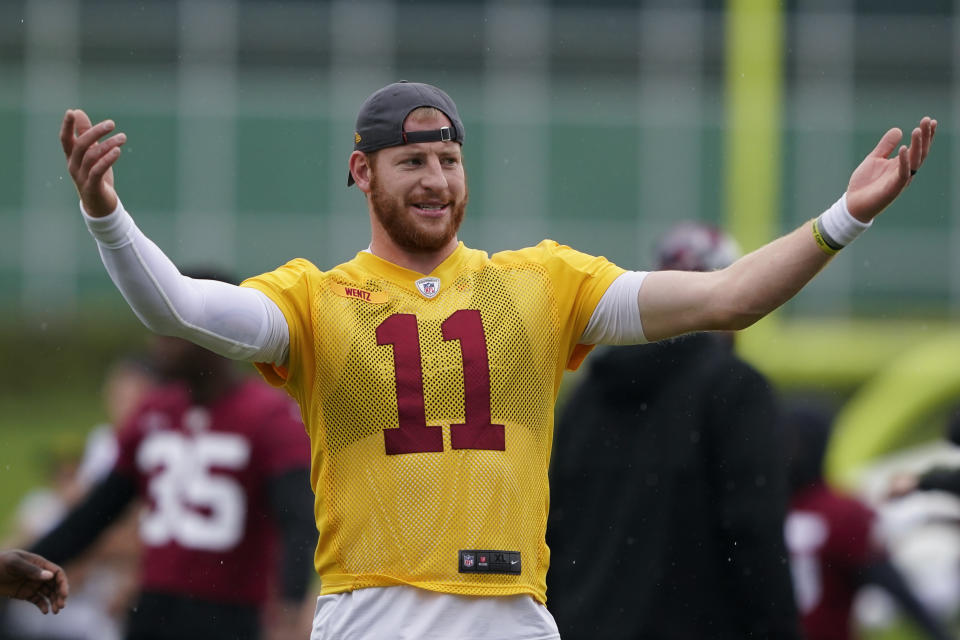 Washington Commanders quarterback Carson Wentz stretches during practice at the team's NFL football training facility, Tuesday, May 24, 2022 in Ashburn, Va. (AP Photo/Alex Brandon)