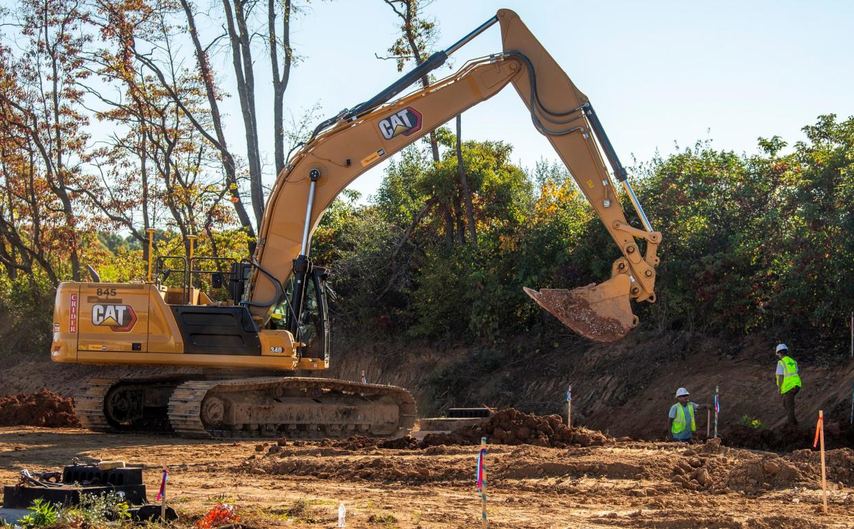 Construction crews dig a trench on a parcel along Liberty Drive that will be a new Kia automobile dealership on Tuesday, Oct. 3, 2024.