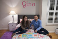 Husband and wife Bryan and Julie Hanlon sit in their adopted daughter's bedroom at their home in Washington, D.C., Tuesday, Feb. 7, 2023. The Hanlons became the legal parents of the Haitian six-yar-old girl and her five-year-old brother Peterson in 2022 but fear they won't be able to secure their passports and fly them out of Haiti. (AP Photo/Cliff Owen)