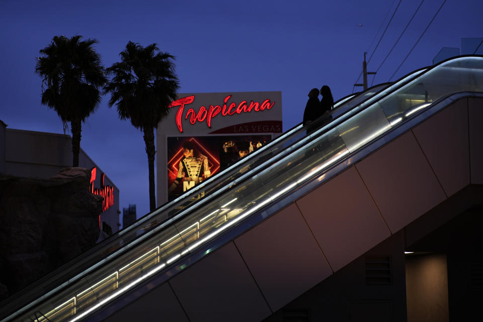 People ride and escalator outside of the Tropicana hotel-casino Thursday, March 28, 2024, in Las Vegas. Known for its constant reinvention, Las Vegas will lose yet another jewel of its past on Tuesday, April 2, 2024, when the Strip’s third-oldest casino, Tropicana Las Vegas, closes its doors for good. (AP Photo/John Locher)