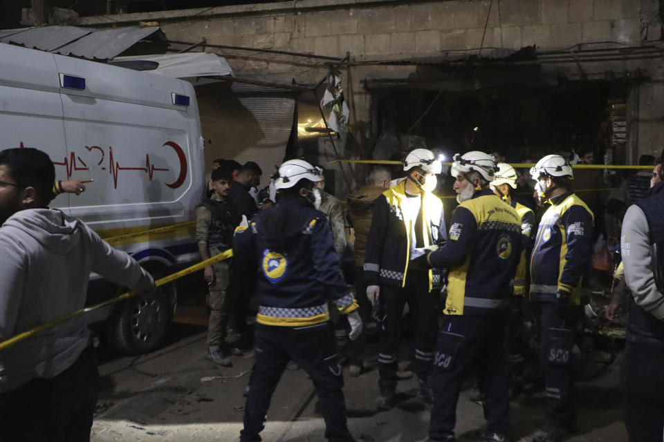 In this photo provided by the Syrian Civil Defense White Helmets, which has been authenticated based on its contents and other AP reporting, Syrian White Helmet civil defense workers search for casualties after a car bomb exploded in a busy market in the Turkish-controlled northwestern city of Azaz, Syria, early Sunday, March 31, 2024. The explosion that tore through the busy market killing at least three people and wounded five civilians, the paramedic group said, and destroyed shops and homes in the area. (Syrian Civil Defense White Helmets via AP)