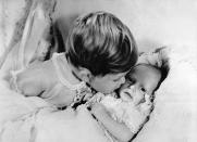 <p>Prince Charles, 2, gives his newborn sister, Princess Anne, a kiss on the cheek. Prince George and Princess Charlotte were photographed in <a href="https://www.harpersbazaar.com/celebrity/latest/a20197532/prince-louis-first-official-photo-compared-to-princess-charlotte/" rel="nofollow noopener" target="_blank" data-ylk="slk:similar poses;elm:context_link;itc:0;sec:content-canvas" class="link ">similar poses</a> for their first photos with their siblings. </p>