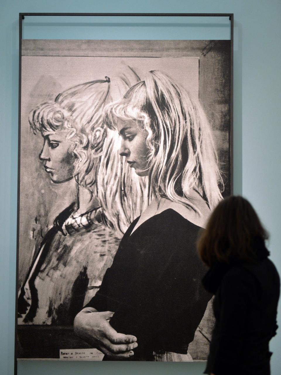 An image of a young Sylvette standing in front of Picasso’s painting of her, on display in the Kunsthalle museum in Germany (AFP via Getty Images)