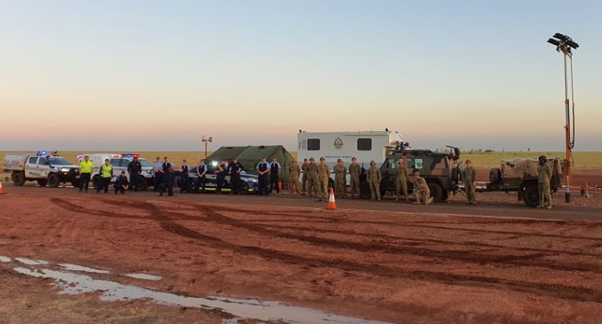 AFP and NT Police stand at the border of Queensland and the Northern Territory.