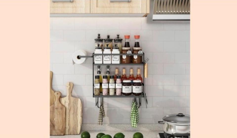 Two-tiered storage unit mounted to kitchen wall.