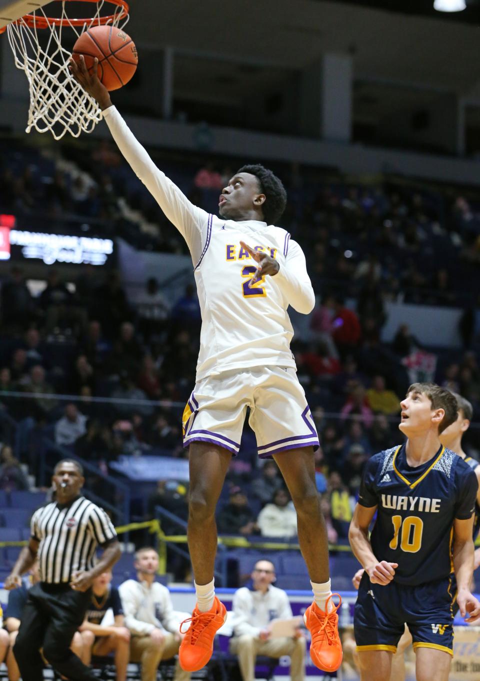 East's Micah Johnson-Breedlove drives to the basket in the opening quarter.