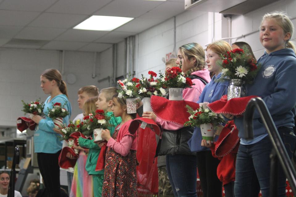 Monroe County 4-H youth are shown at the auction at the recent Toys, Trains and Candy Canes event. All items, including the table centerpieces and the mantle, were auctioned to raise money for the local 4-H program.