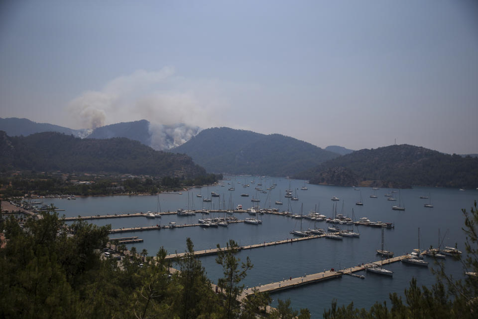 A wildfire burns the forest in Turgut village, near tourist resort of Marmaris, Mugla, Turkey, Wednesday, Aug. 4, 2021. As Turkish fire crews pressed ahead Tuesday with their weeklong battle against blazes tearing through forests and villages on the country's southern coast, President Recep Tayyip Erdogan's government faced increased criticism over its apparent poor response and inadequate preparedness for large-scale wildfires.(AP Photo/Emre Tazegul)