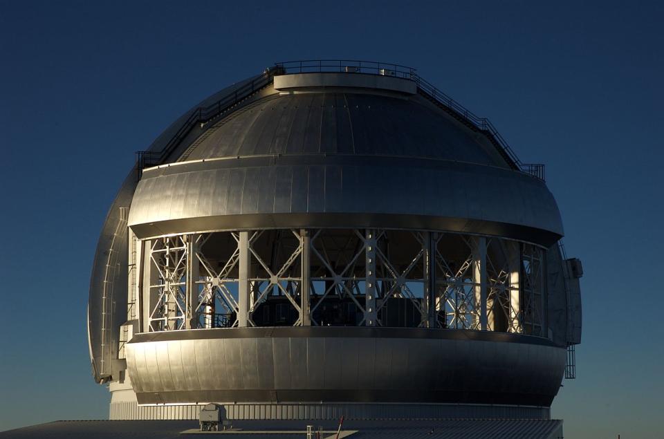 a silver telescope dome with a large opening