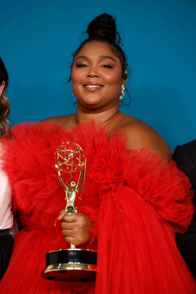 Lizzo holding an award