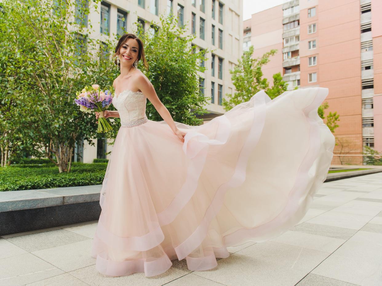 Bride wearing a pink wedding dress.
