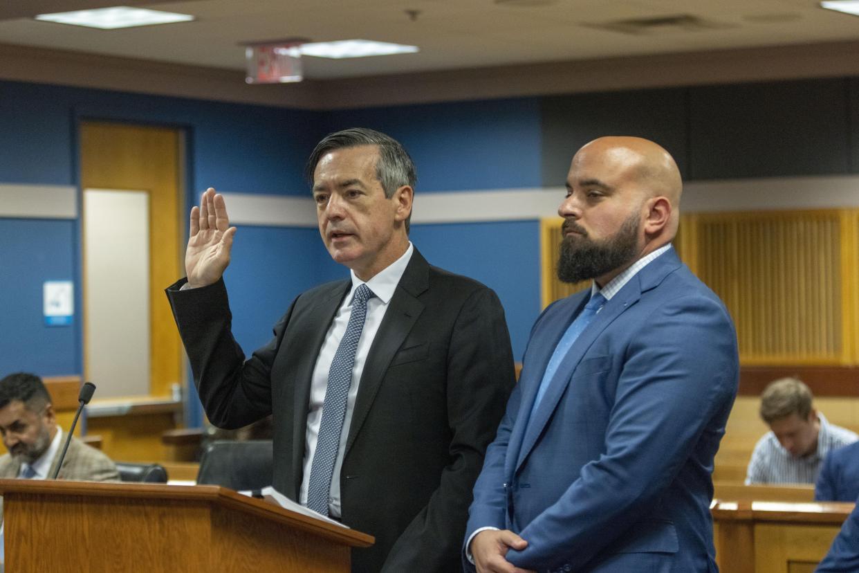 Kenneth Chesebro raises his hand as he's sworn in during a plea deal hearing.
