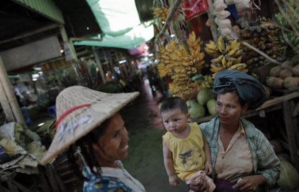 Women chat at a market in capital Naypyitaw, January 24, 2012.