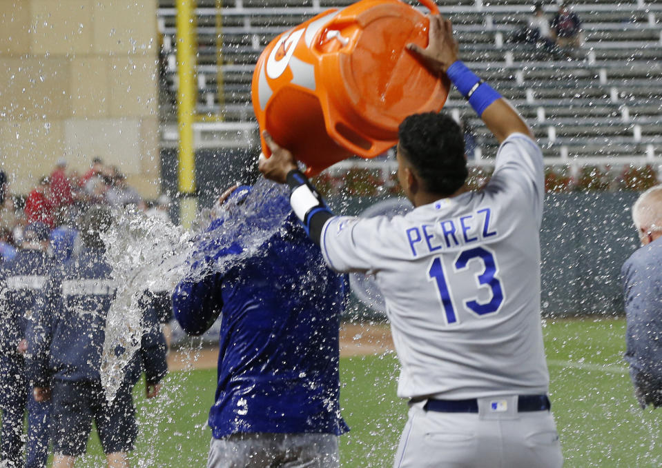 Kansas City Royals pitcher Jorge Lopez gets doused by catcher Salvador Perez, right, after a baseball game against the Minnesota Twins on Saturday, Sept. 8, 2018, in Minneapolis. Lopez had a perfect game through eight innings, but gave up a walk and a hit in the ninth, and was pulled. The Royals won 4-1. (AP Photo/Jim Mone)