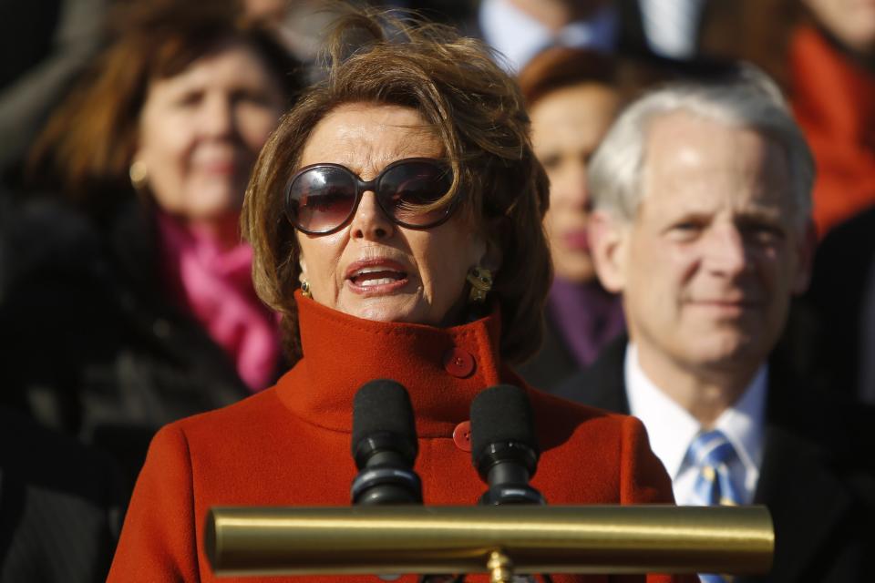 U.S. House Minority Leader Nancy Pelosi (D-CA), standing with fellow House Democrats, delivers remarks on immigration legislation on the steps of the U.S. Capitol in Washington January 13, 2015. REUTERS/Jonathan Ernst (UNITED STATES - Tags: POLITICS SOCIETY IMMIGRATION)