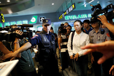 Lee Ching-yu, wife of Taiwan human rights advocate Lee Ming-che, also known as Li Ming-Che, who has been detained in China, departs for her husband's trial from the airport in Taipei, Taiwan September 10, 2017. REUTERS/Tyrone Siu