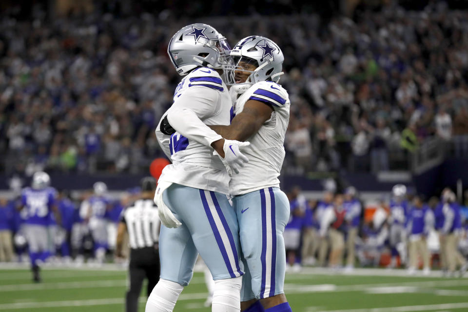 Dallas Cowboys' Chauncey Golston, left, and Micah Parsons, right, celebrate late in the second half of an NFL football game against the Seattle Seahawks in Arlington, Texas, Thursday, Nov. 30, 2023. (AP Photo/Roger Steinman)