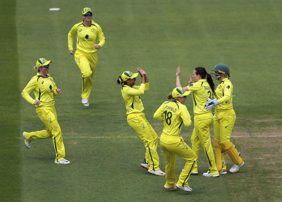 Australia's Megan Schutt celebrates with teammates after bowling out England's Tammy Beaumont during the third one day international of the Women's Ashes Series at the at Cooper Associates County Ground, Taunton, England, Tuesday July 18, 2023. (Steven Paston/PA via AP)