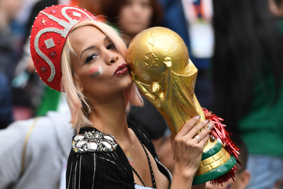 <p>A Russian fan kisses a replica of the FIFA 2018 World Cup trophy before the Russia 2018 World Cup Group A football match between Russia and Saudi Arabia at the Luzhniki Stadium in Moscow on June 14, 2018. (Photo by Kirill KUDRYAVTSEV / AFP) </p>