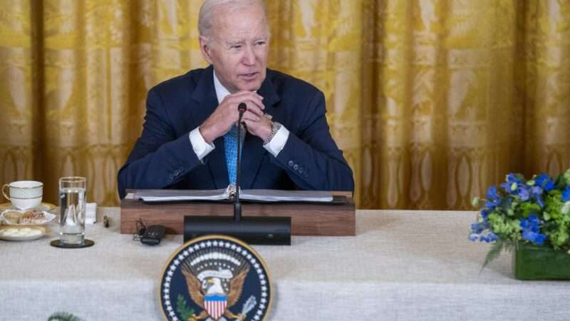 Joe Biden delivers remarks from a lectern at a White House summit