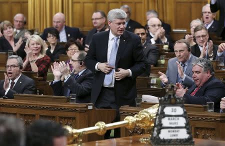 Canada's Prime Minister Stephen Harper stands to vote in the House of Commons on Parliament Hill in Ottawa March 30, 2015. REUTERS/Chris Wattie