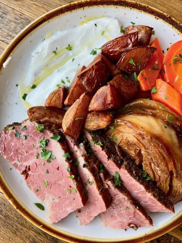 Corned beef with braised cabbage, crispy red herb potatoes, roasted carrots, horseradish crema and parsley oil at Half Moon in Keansburg.