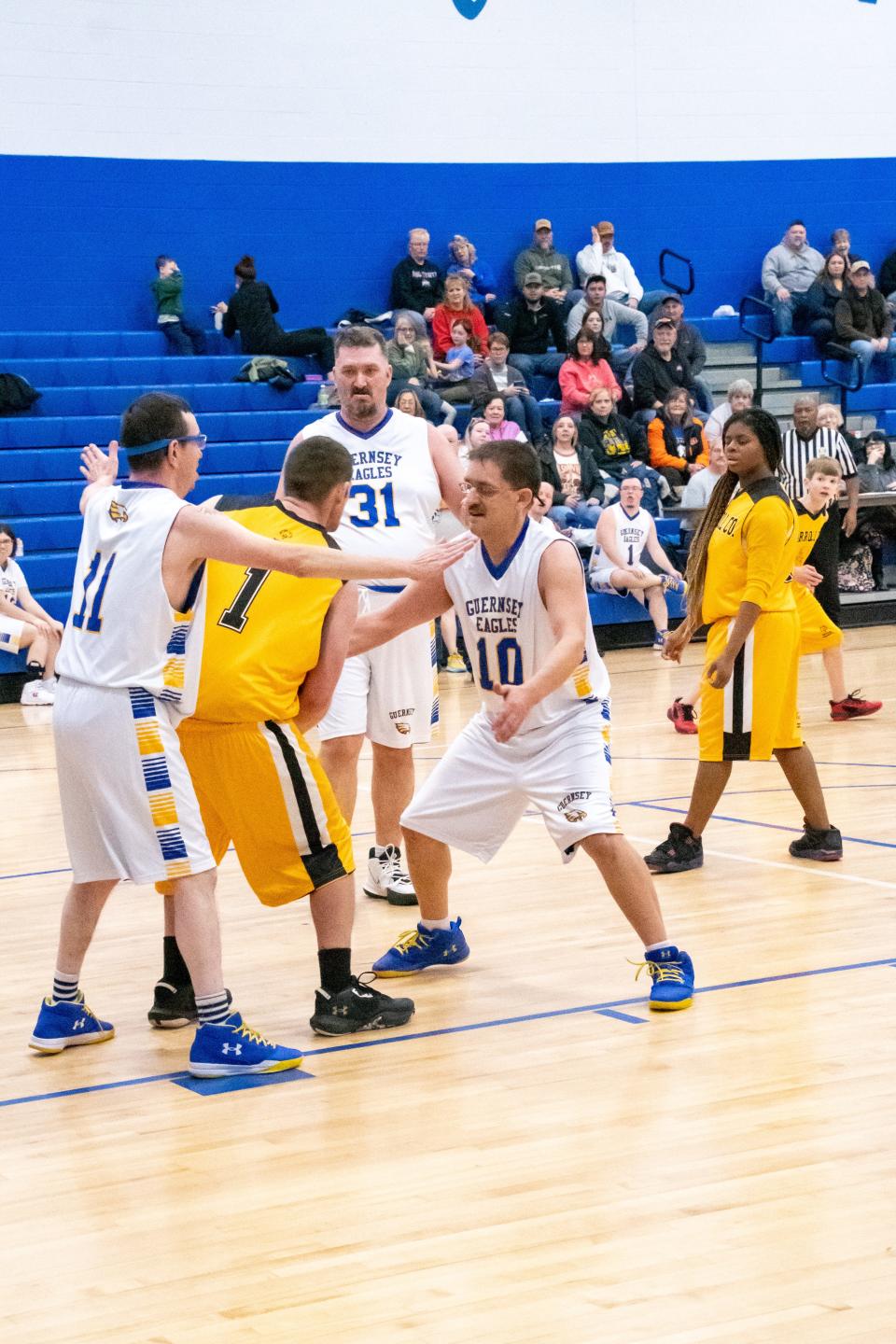 Jason Hall (11) and Adam Finch (10) defend against Carroll County Cougars top scorer for the evening Noah Hinkle (1) during the Tuesday night matchup.