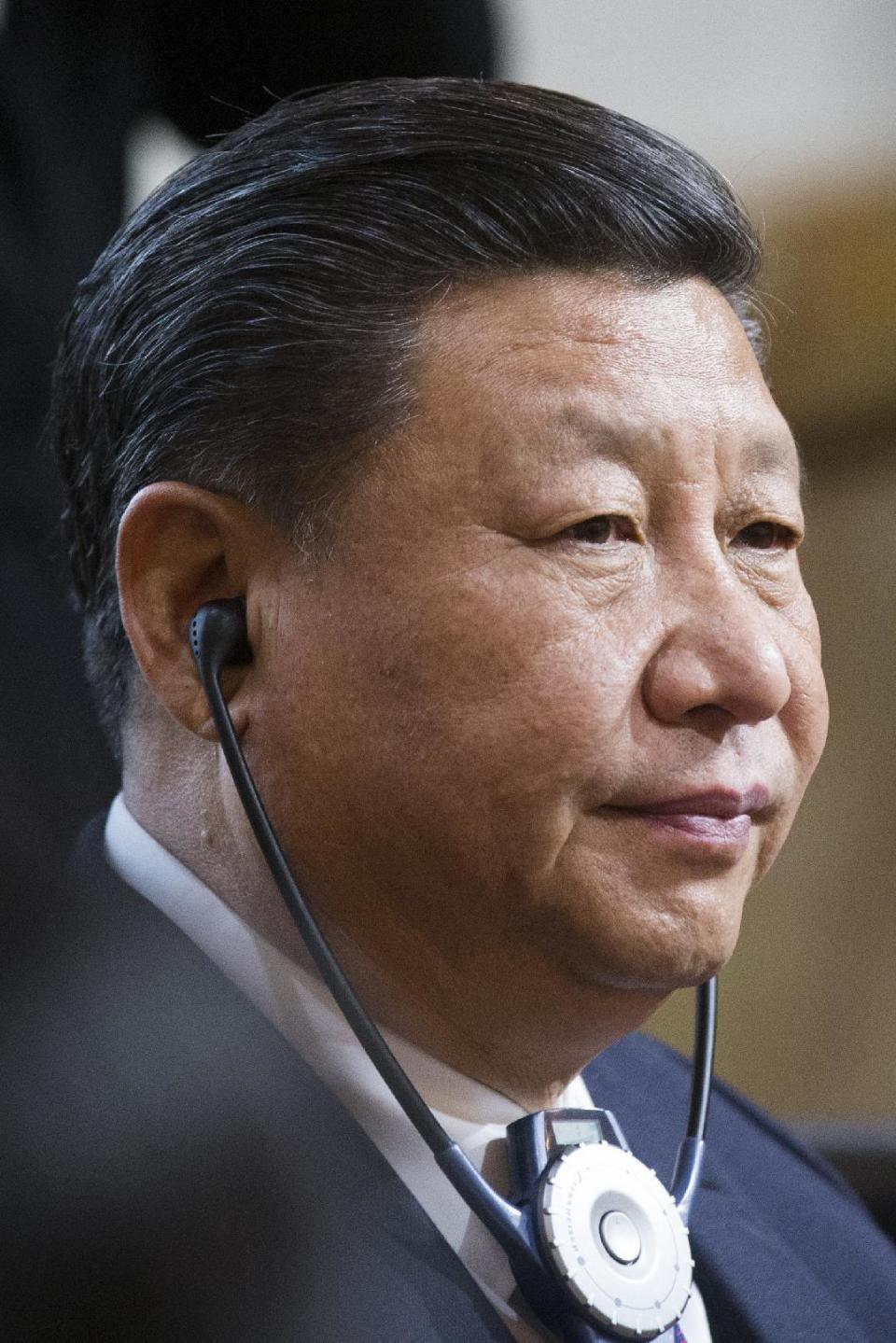 China's President Xi Jinping listens to the speech of Swiss Federal President Doris Leuthardin the house of parliament during his two days state visit to Switzerland in Bern, Switzerland, on Sunday, Jan. 15, 2017. (Peter Klaunzer/Pool Photo via AP)