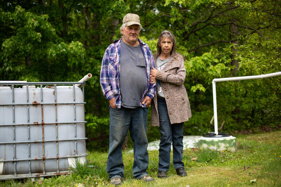 Burl and Delphine Stacy live on a mountain ridge, just one mile from a public water line, but have to rely on rainwater and bottled water to drink, wash and cook with. (Hannah Rappleye / NBC News)