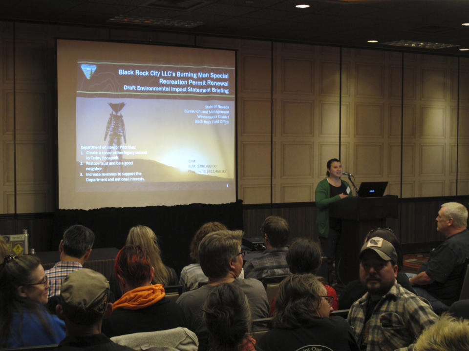 Chelsea McKinney, outdoor recreation coordinator for the U.S. Bureau of Land Management in Nevada, describes a draft environmental impact statement for the Burning Man event during a meeting in Sparks, Nev., on Monday, April 8, 2019. Nearly 200 Burning Man backers packed the room to mostly complain about new conditions and restrictions the government wants to place on the counter-culture festival in the northern Nevada desert. (AP Photo/Scott Sonner)