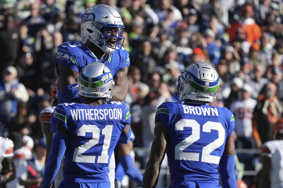 Seattle Seahawks linebacker Boye Mafe (53) celebrates with teammates Devon Witherspoon (21) and Tre Brown (22) after a sack of Cleveland Browns quarterback PJ Walker in the first half of an NFL football game, Sunday, Oct. 29, 2023, in Seattle. (AP Photo/Ted S. Warren)