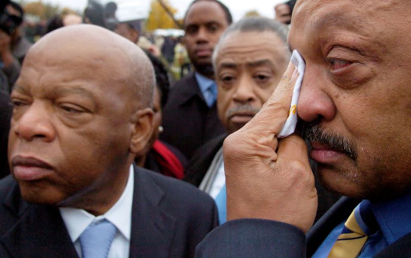 FILE PHOTO: Civil rights leaders Rep. John Lewis (D-GA), L-R, Rev. Al Sharpton and Rev. Jesse Jackson gather after the groundbreaking ceremony for the Martin Luther King Jr. Memorial on the National Mall in Washington