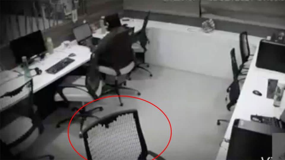 The worker has her headphones in but she notices something strange is happening. Photo: Facebook