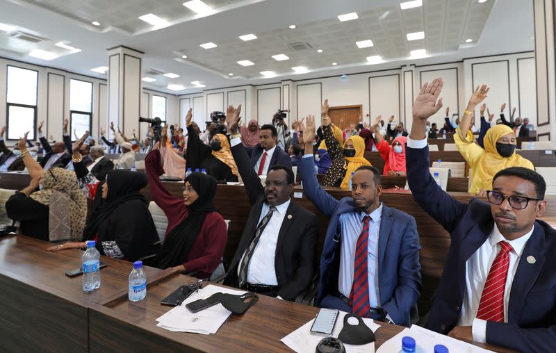 Somali legislators of the lower house of parliament raise their hands to vote to extend President Mohamed Abdullahi Mohamed's term for another two years to let the country prepare for direct elections, in Mogadishu