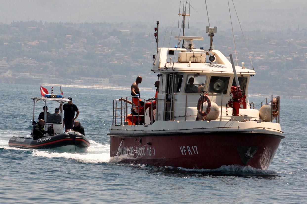 Divers with the body of Hannah Lynch, the last missing person, at the back of the boat off Sicily's coast,