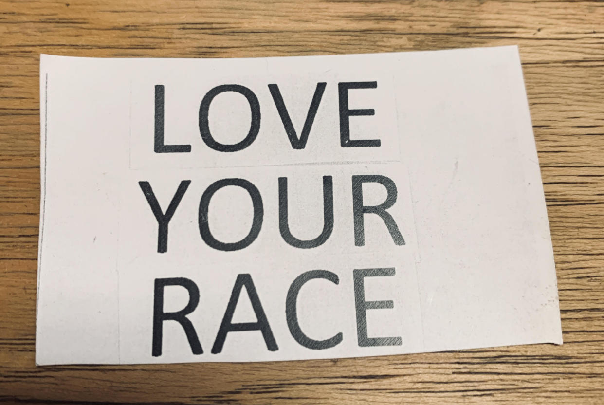 A sign that read "LOVE YOUR RACE" was posted outside on the store front of a local business called Broomstick Betty. (Credit: Jacqueline Laven)