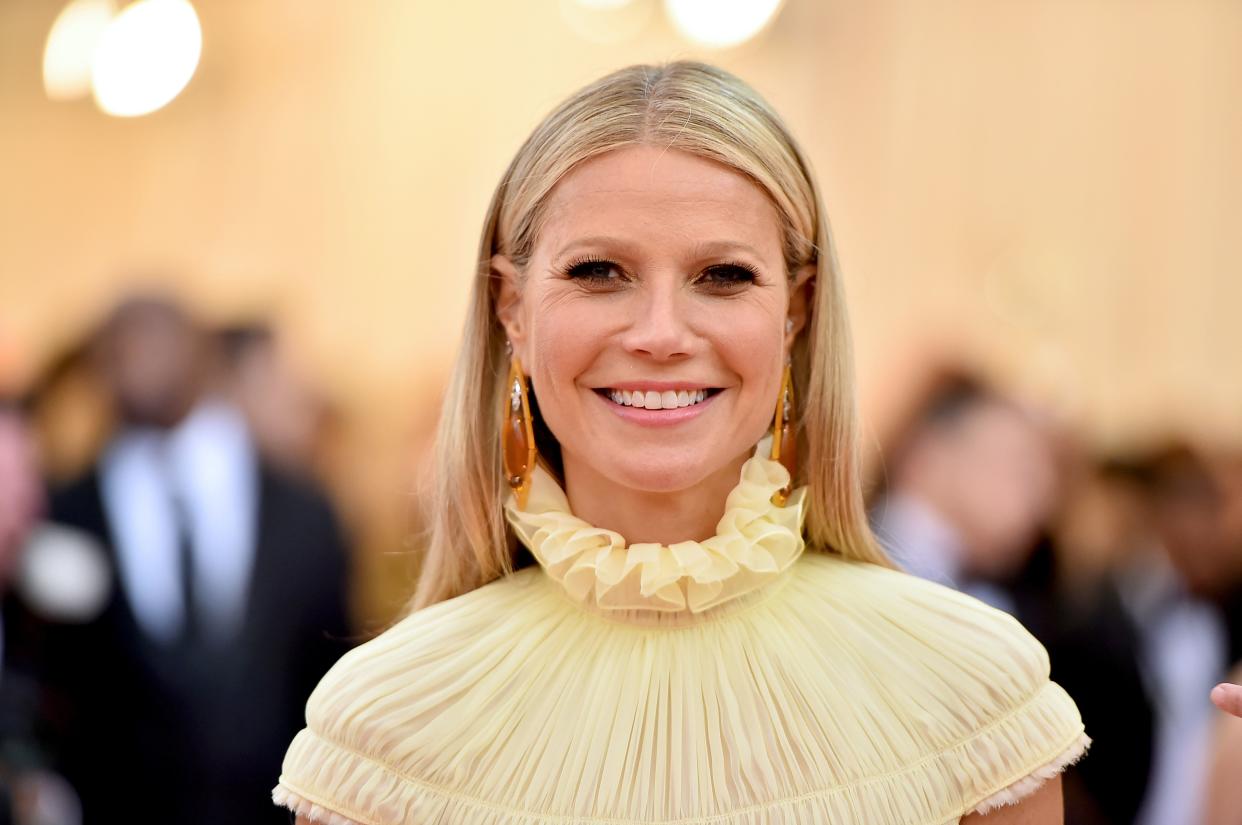 Gwyneth Paltrow in frilly yellow top.