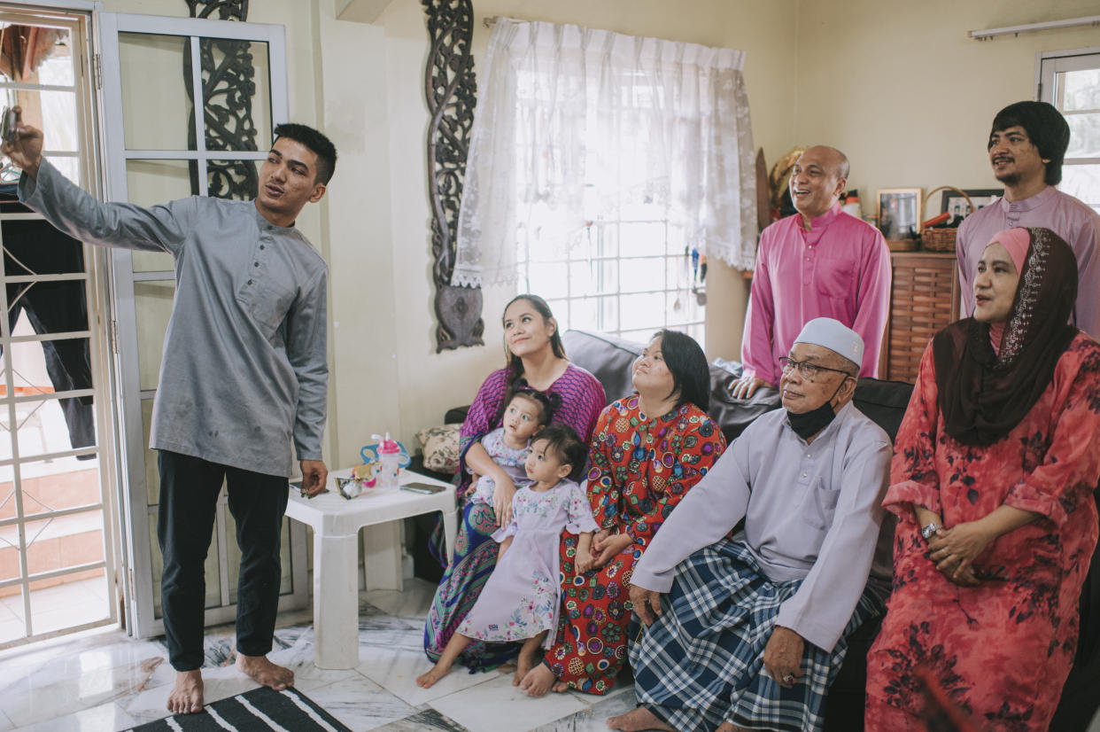 Multi generation family taking selfie photograph at living room during Hari Raya. PHOTO: Getty Images