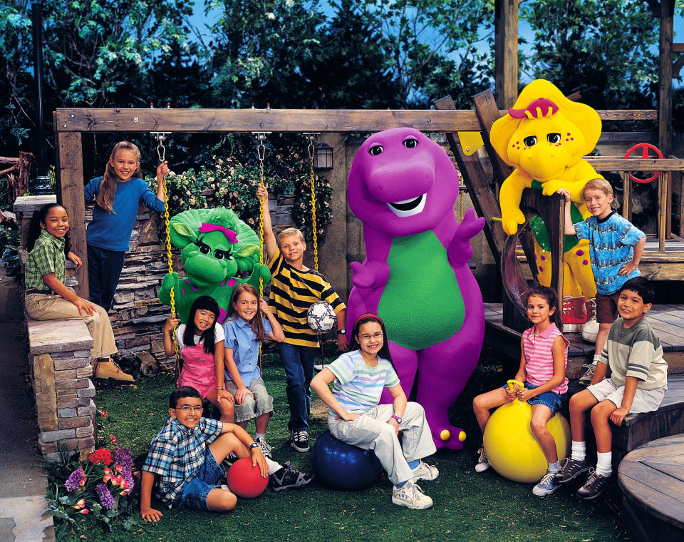 Barney the dinosaur, Selena Gomez (on yellow ball), Demi Lovato (wearing glasses and red headband)