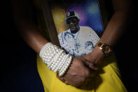 Daphne Bolton poses for a portrait holding a photograph of her brother at her home on Monday, May 31, 2021, in Charlotte, N.C. Bolton's brother, Johnny Lorenzo Bolton, a 49-year-old Black man was shot to death by a Cobb County Sheriff's Office SWAT team member serving a search warrant last December. (AP Photo/Chris Carlson)